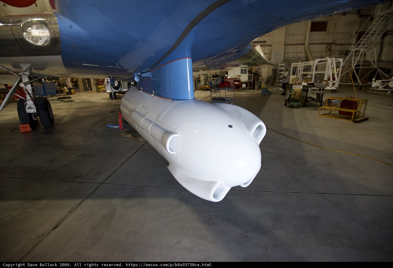 White and Blue Airplane in a Hangar