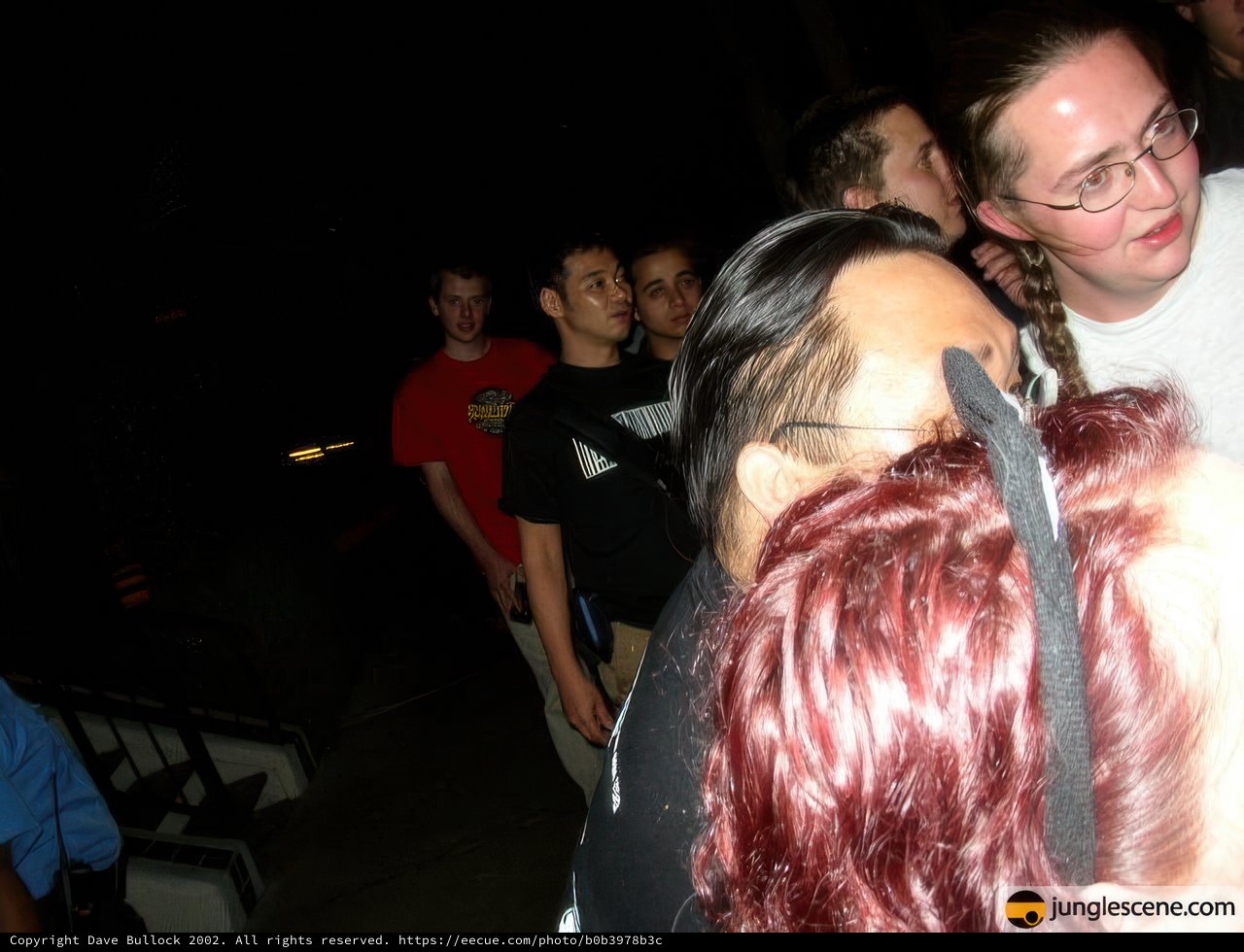 Group Gathering Around Red-Haired Man