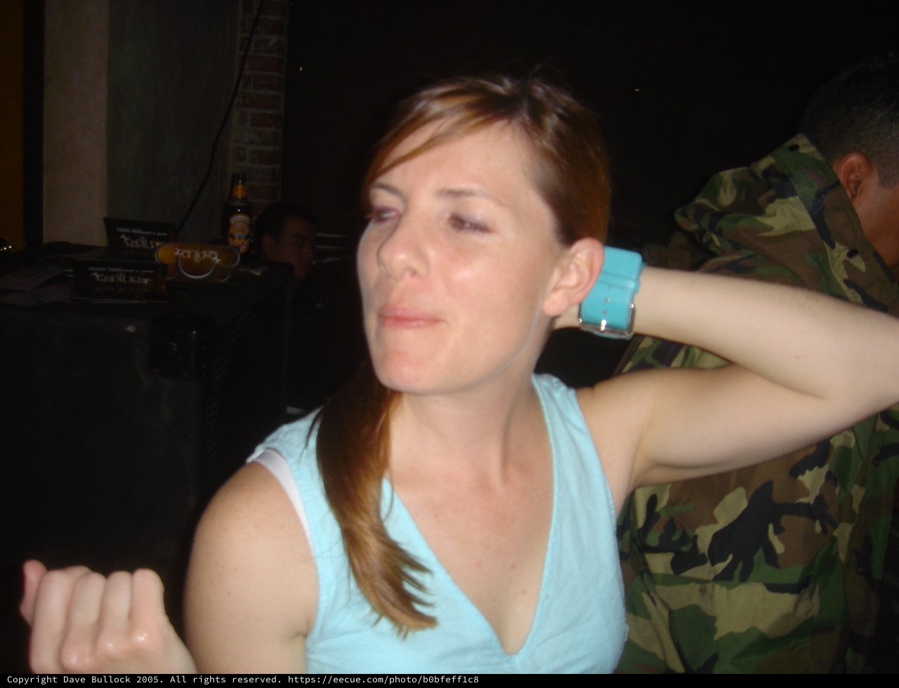 Woman with Black Eye at Nighttime Social Gathering