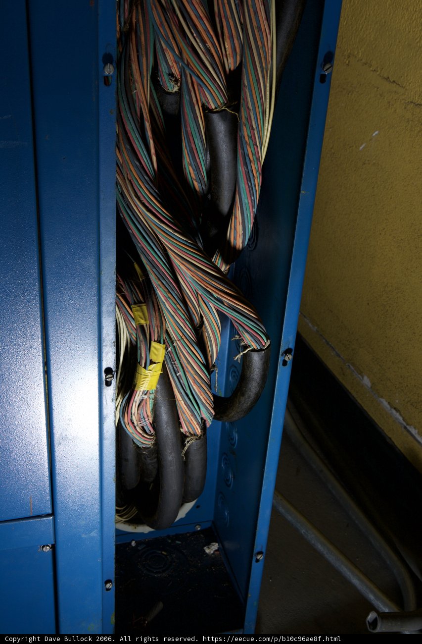 Tangled Wires in a Blue Cabinet