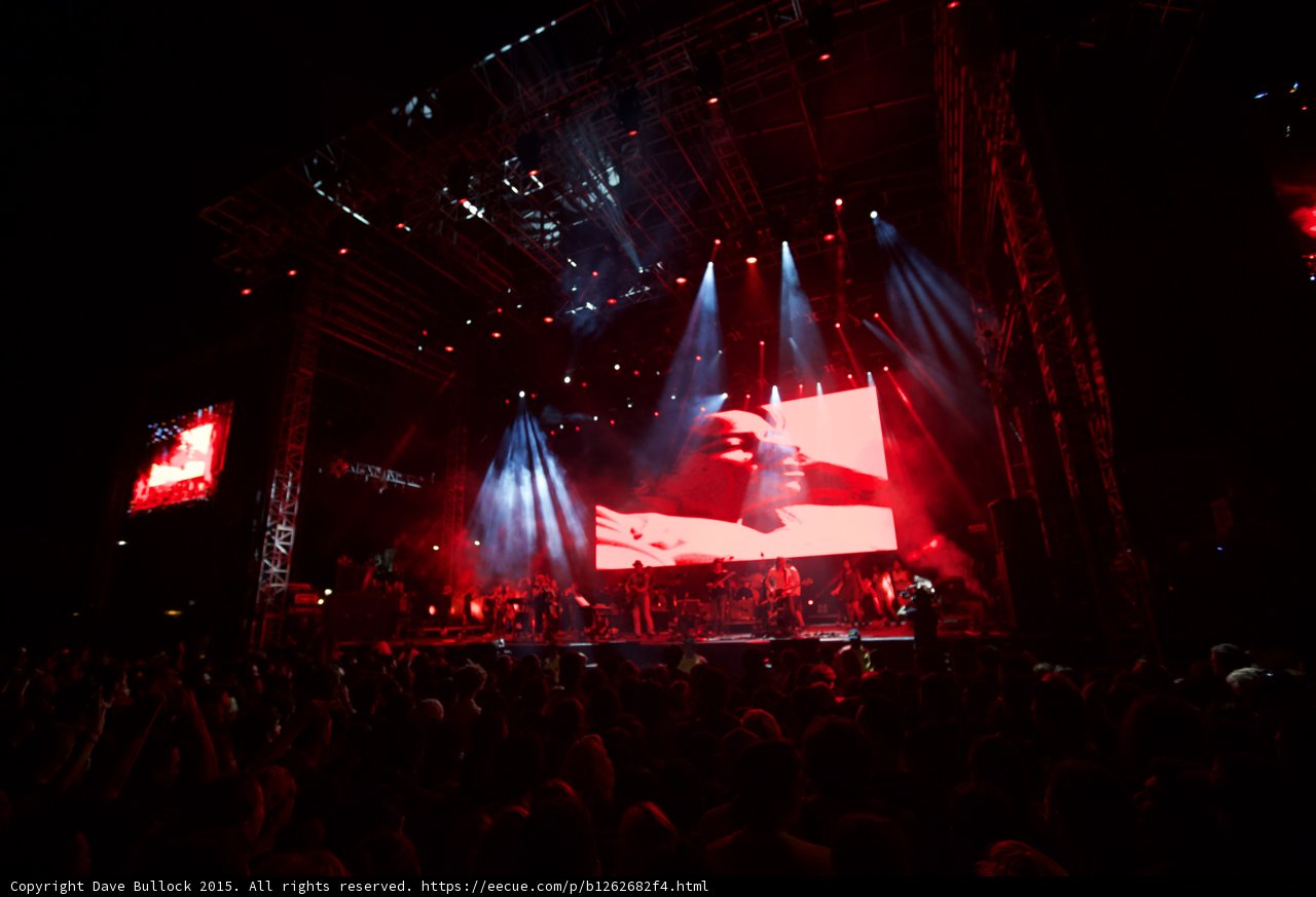 Belle and Sebastian Wide Stage Video Screen Romantic Imagery Red Lighting Spotlight Beams Crowd