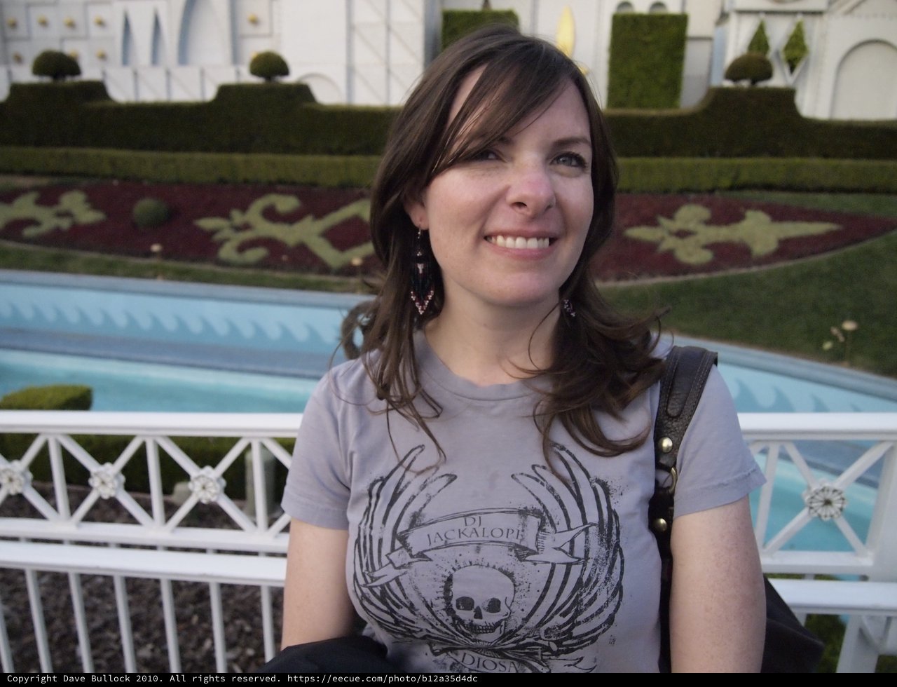 Smiling Woman at Elegant Garden Fountain Setting