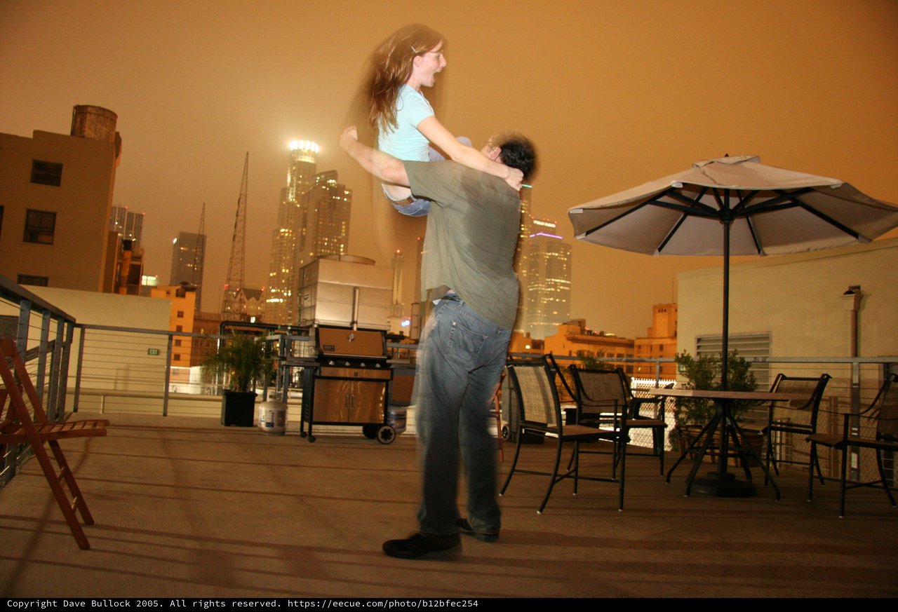 Romantic Rooftop Lift Against LA's Glowing Skyline