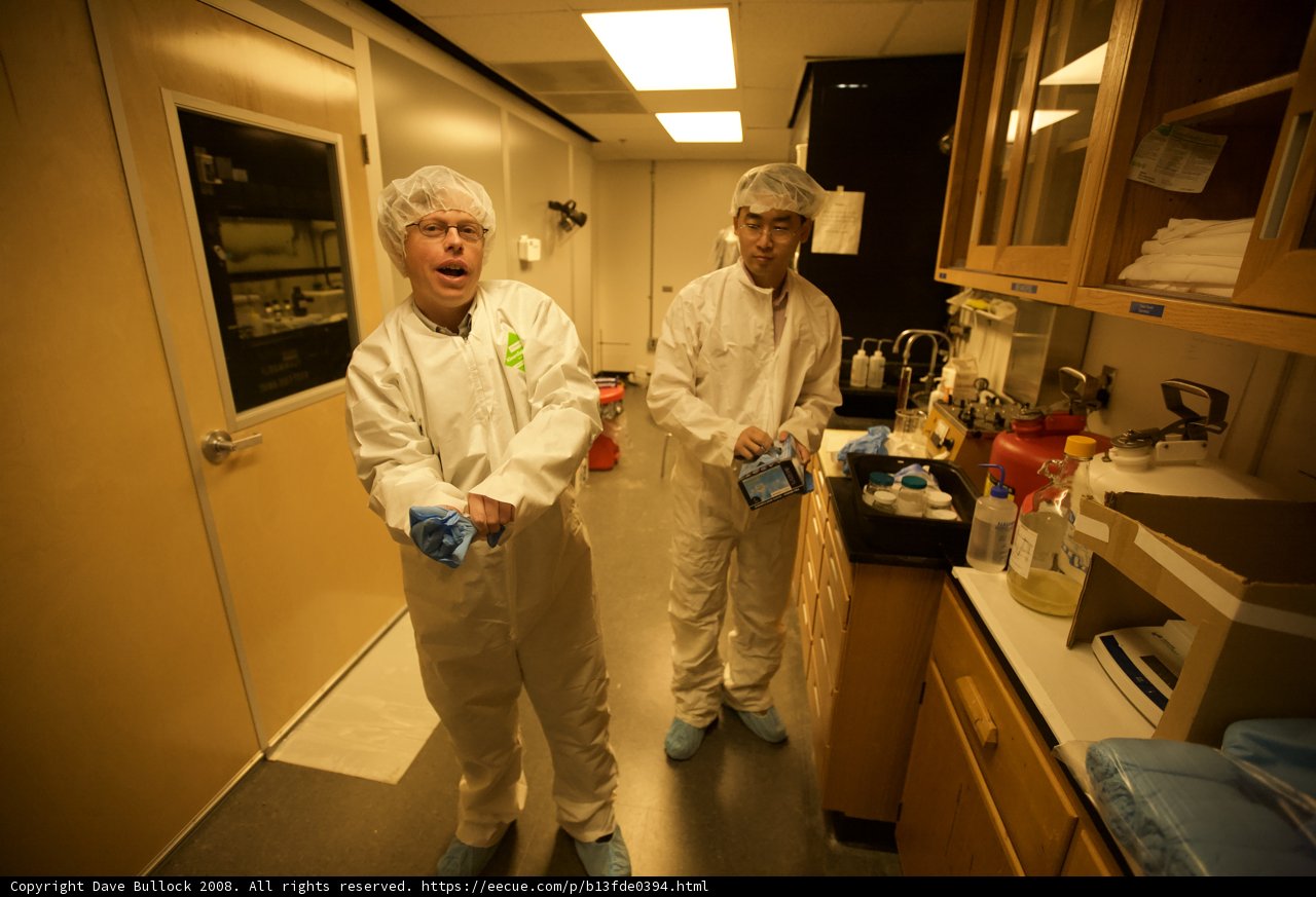 Two Scientists Working in a White Lab