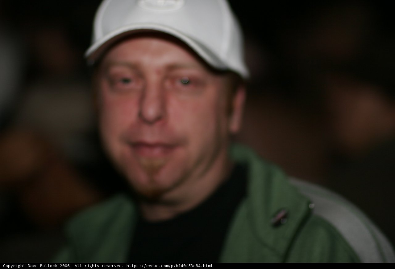 Blurry Man in a White Baseball Cap
