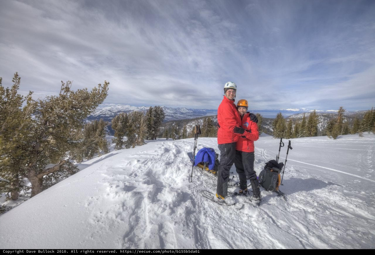 Couple Embracing on Snowy Mountain Summit at Lake Tahoe