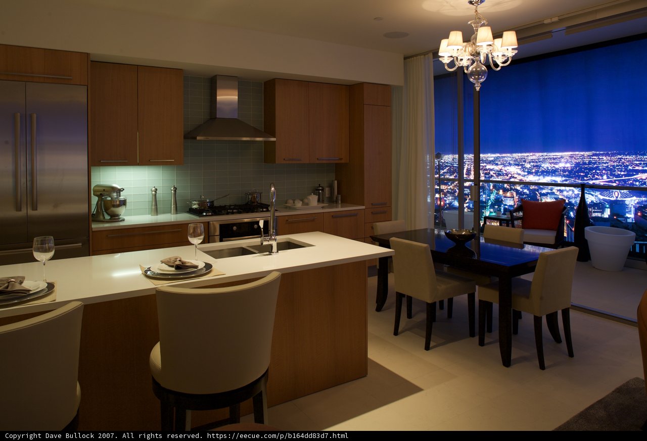 Kitchen with a View Caption: This stunning kitchen in the heart of Park 5th boasts a breathtaking view of the city skyline. Featuring elegant cabinetry, a chandelier, hardwood flooring, and a cozy dining area, this kitchen provides the perfect backdrop for entertaining guests or enjoying a quiet meal at home.