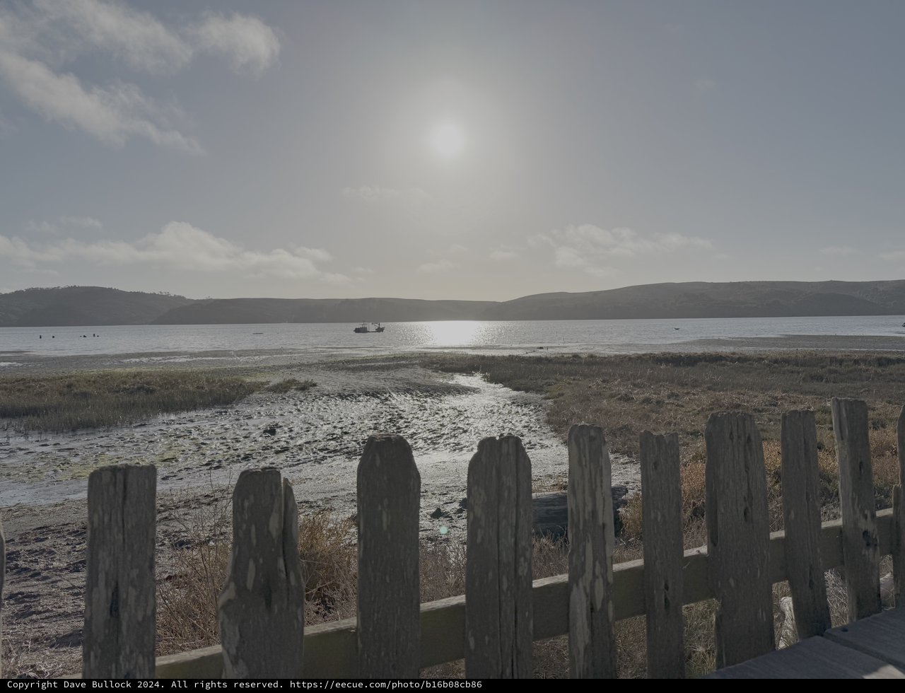 Weathered Fence Overlooking Moody Coastal Waters