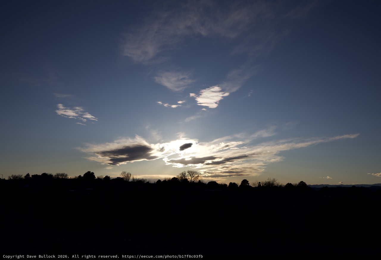 Dramatic Cloud Formation at Sunset Over Silhouetted Landscape