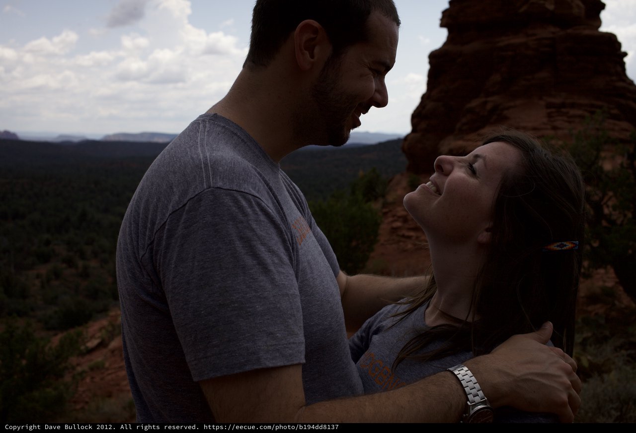 Laughing Couple Embracing Atop Sedona Red Rocks