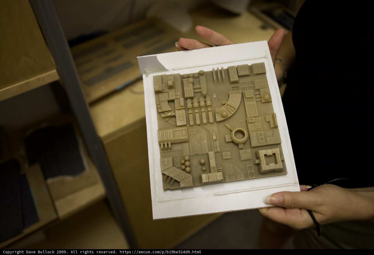 Paper Model of Building in Hands