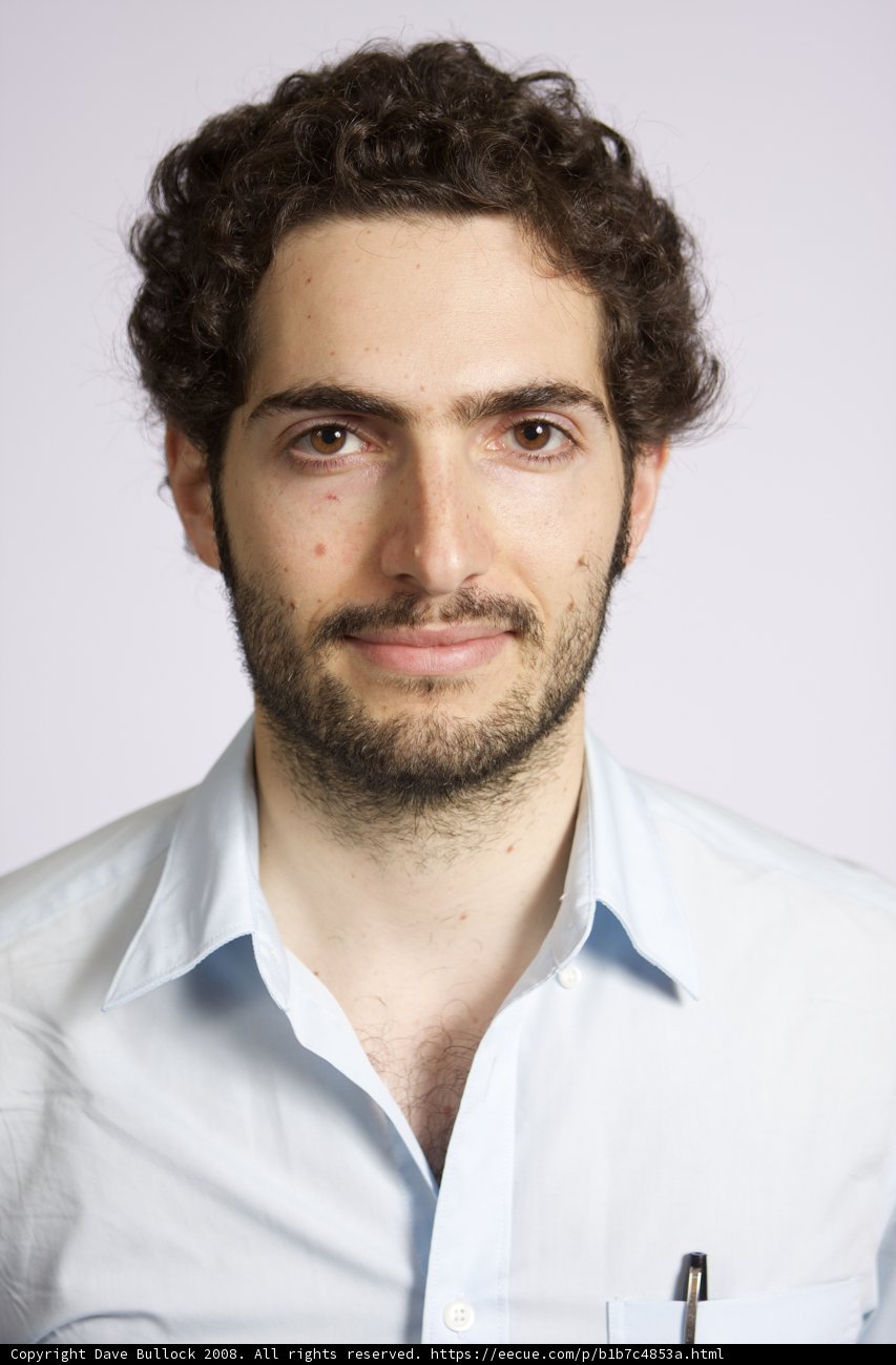 Curly Haired Man in Blue Shirt
