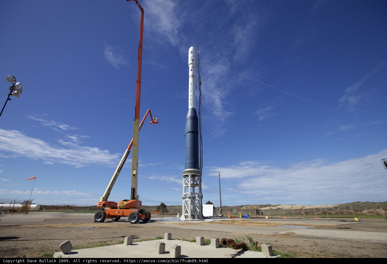Towering Rocket Amidst a Cloudy Sky