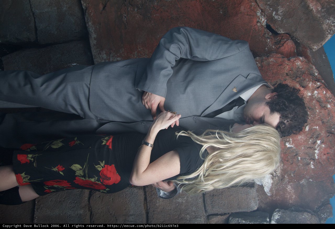 Romantic Kiss Against Ancient Stone Wall