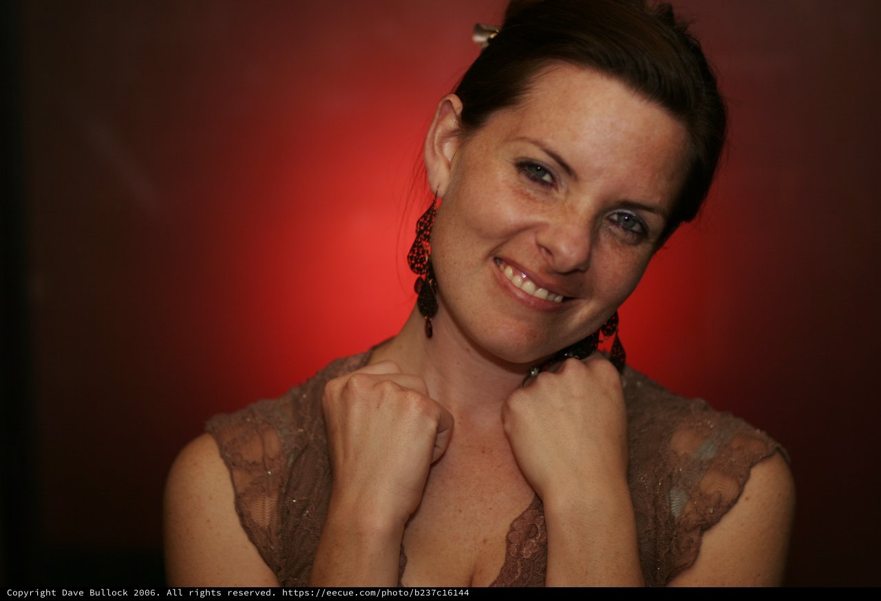 Smiling Woman in Red Light Portrait Session