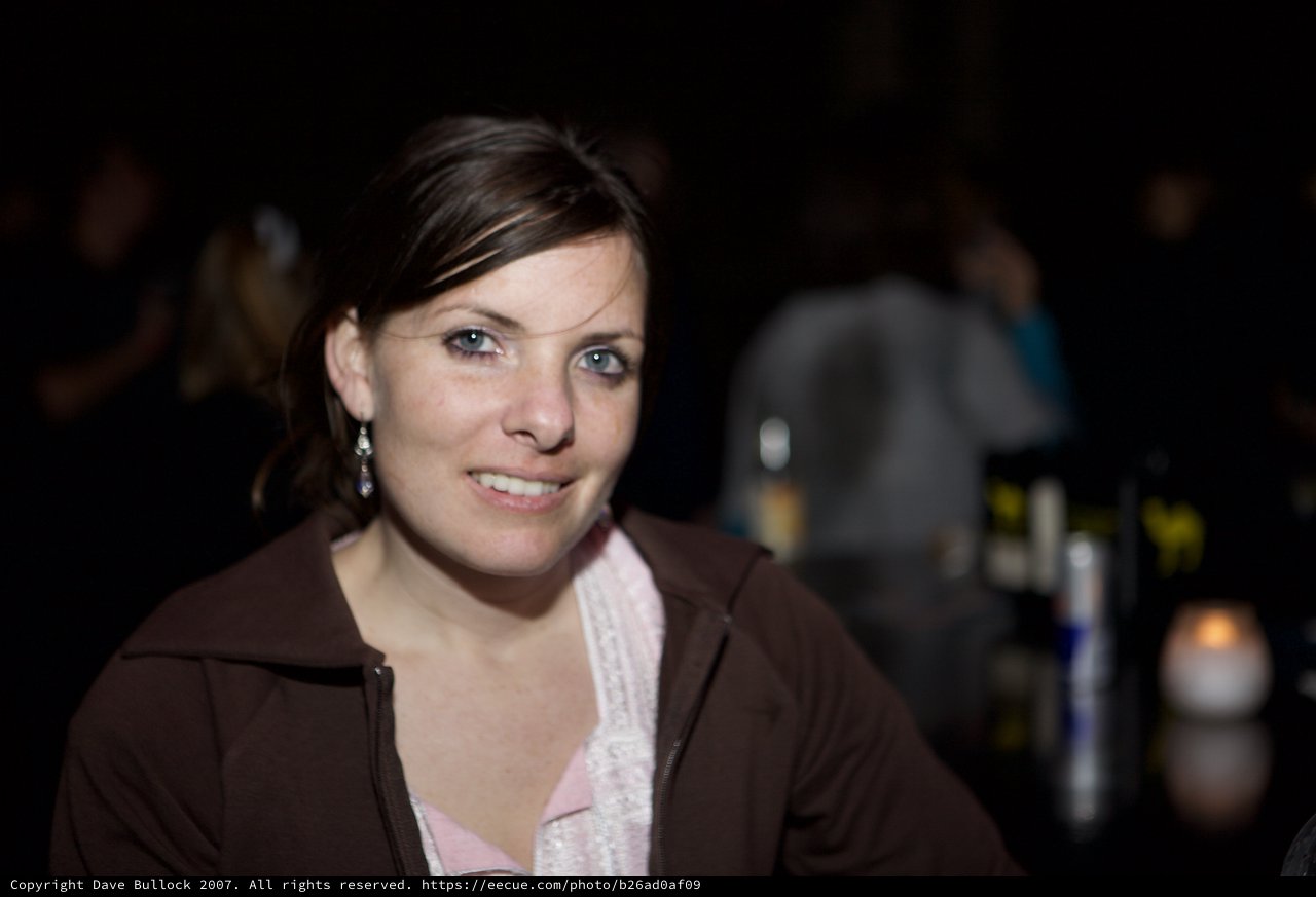 Smiling Woman at Dimly Lit Evening Venue