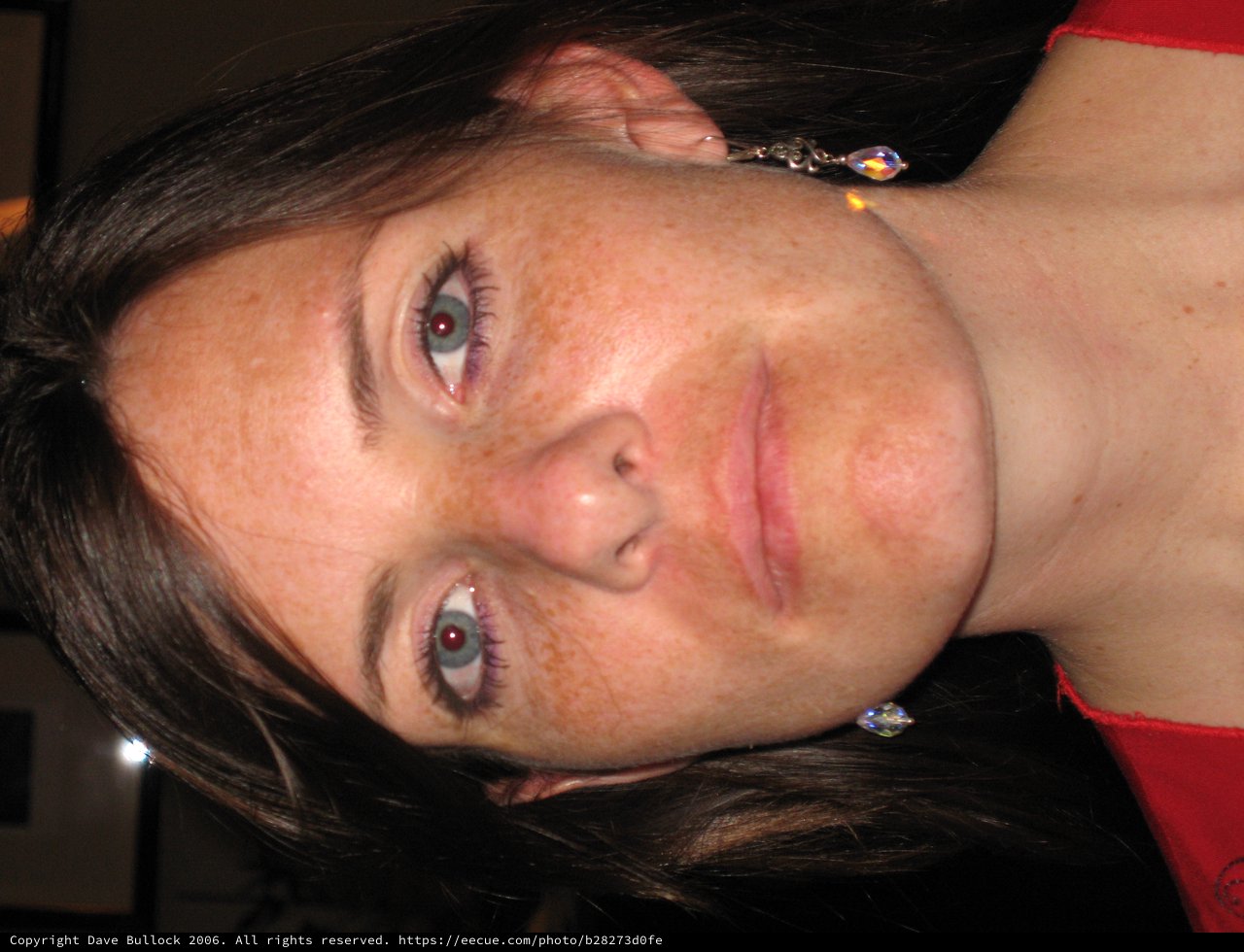 Freckled Woman in Red at Evening Gathering