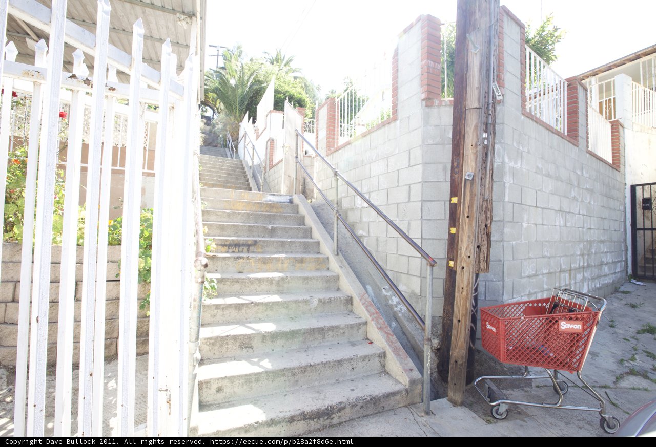 Red Shopping Cart at the Foot of the Stairs