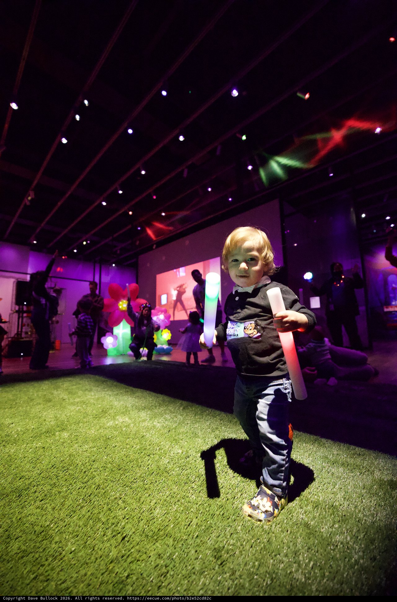 Young Child at Baby Rave Event with Glow Stick