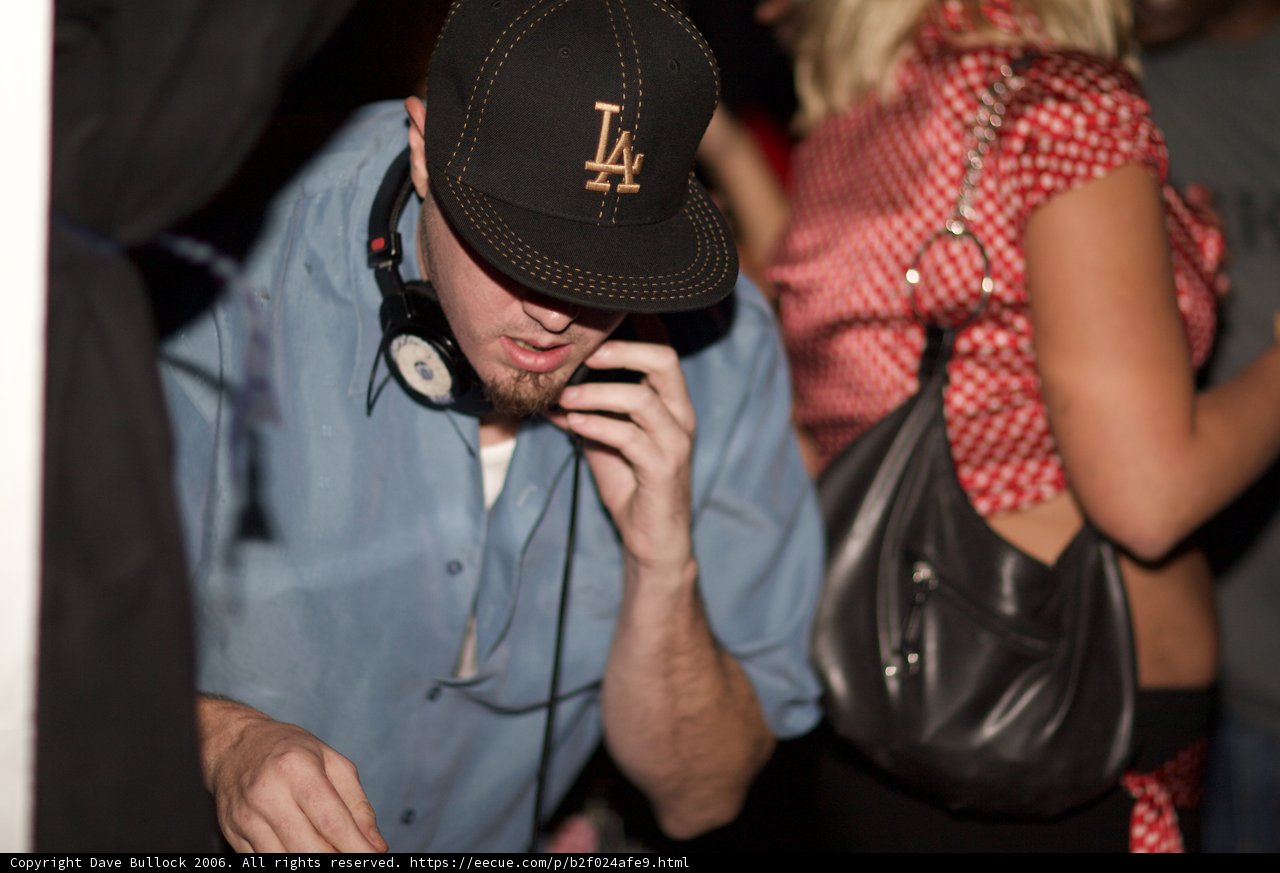 Blue Shirt, Baseball Cap, and Finger In The Air