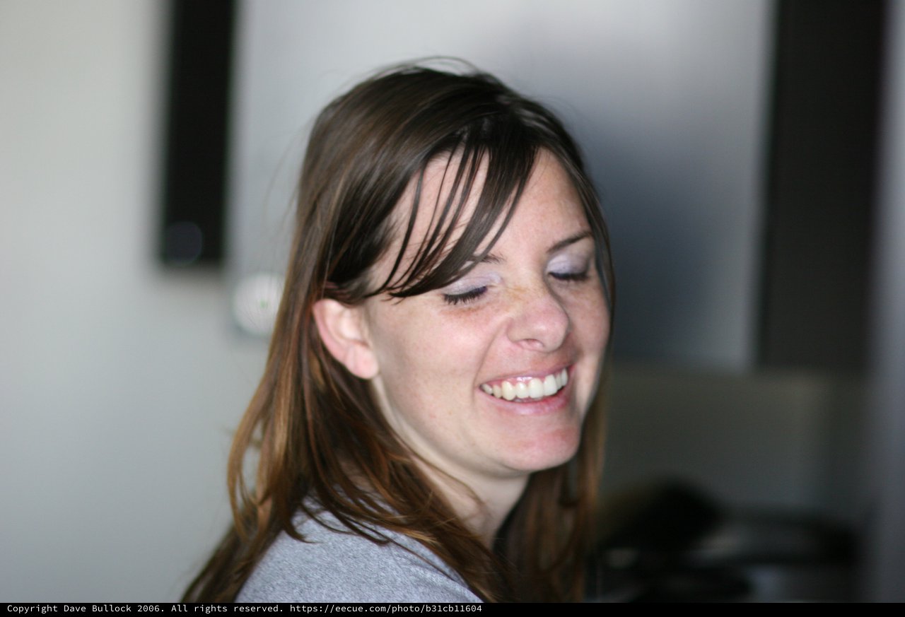 Candid Laughter: Woman Smiling with Eyes Closed
