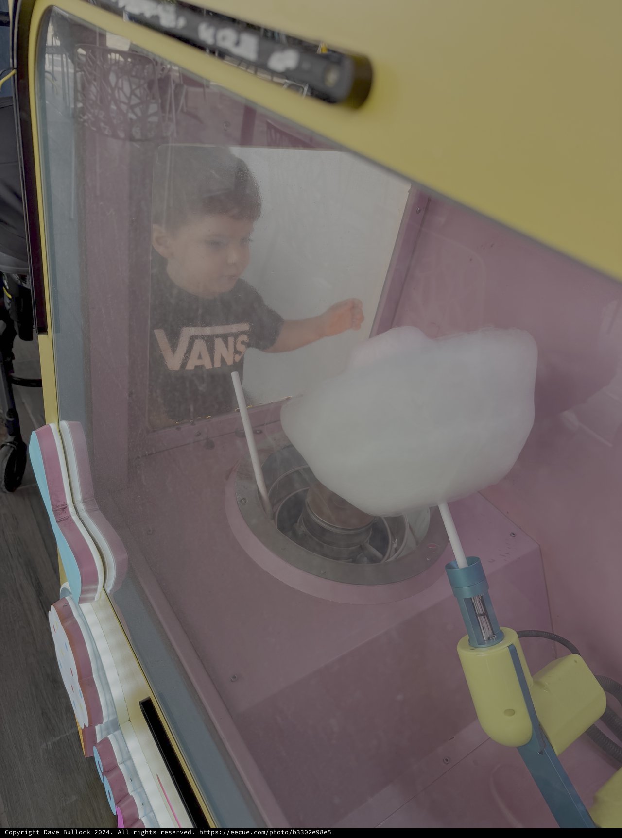 Child Operating Cotton Candy Machine at Fair