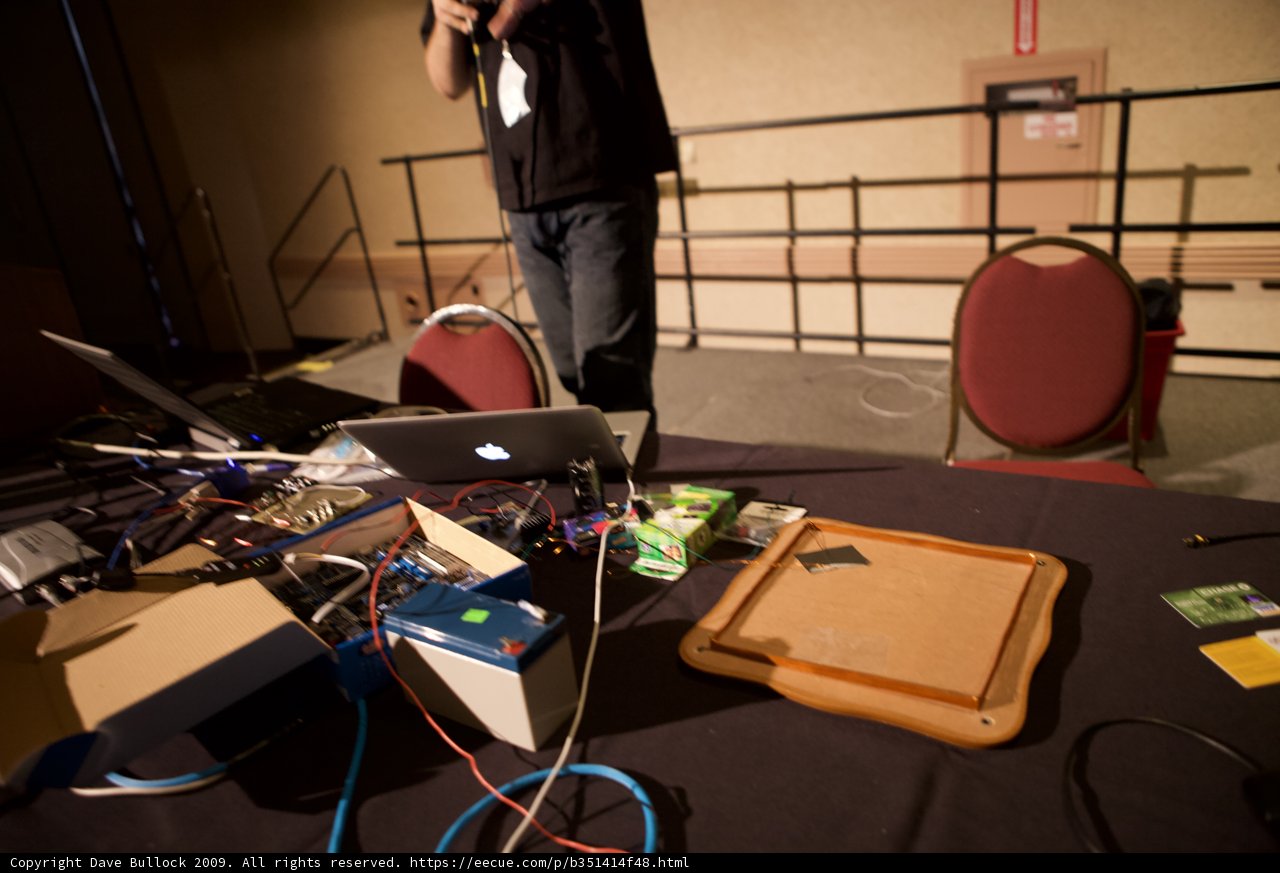 Hard at Work Caption: A man diligently types away on his laptop at the Defcon 17 conference, surrounded by multiple screens and electronics.