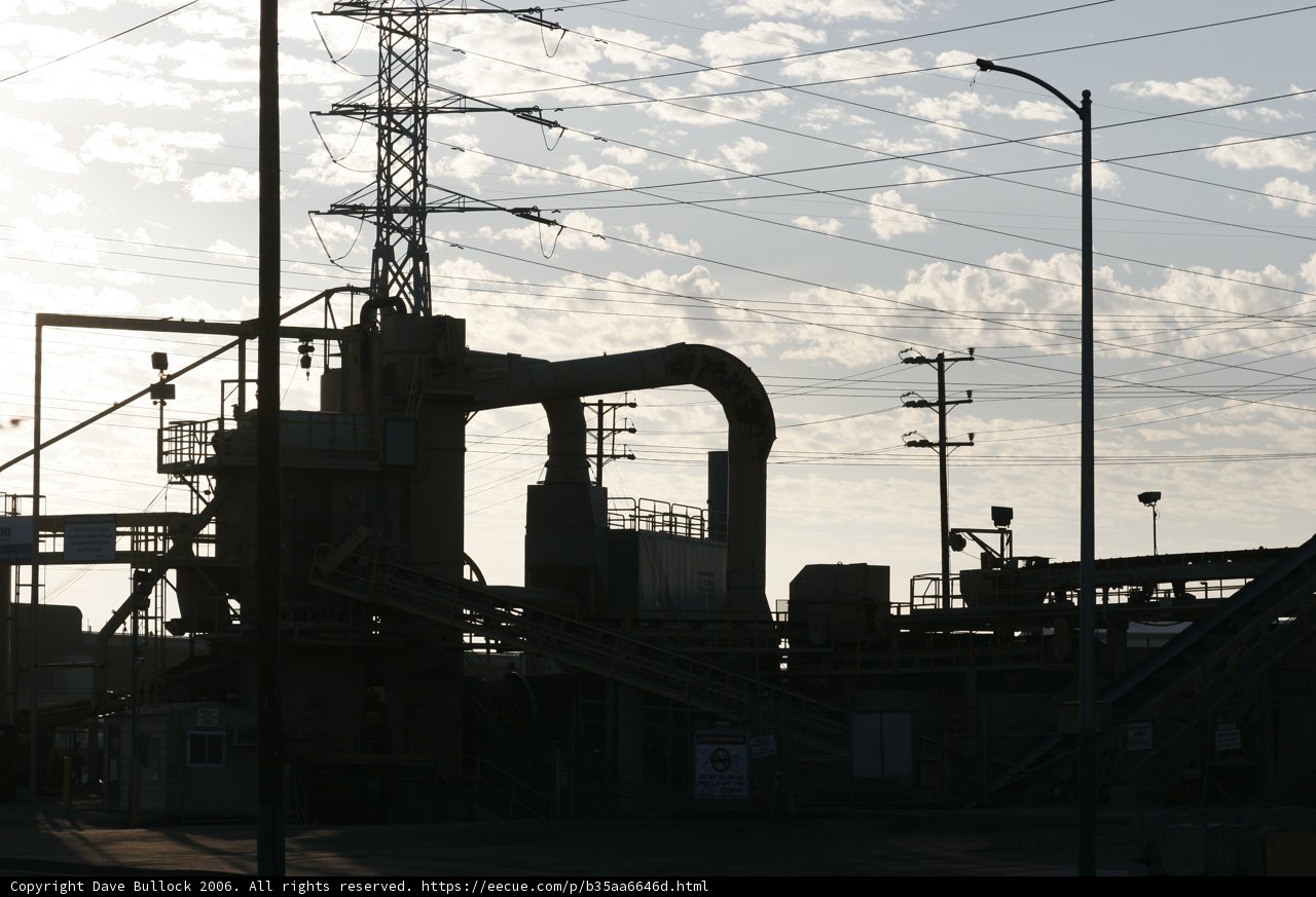 Towering Refinery Building in the Cloudy Sky