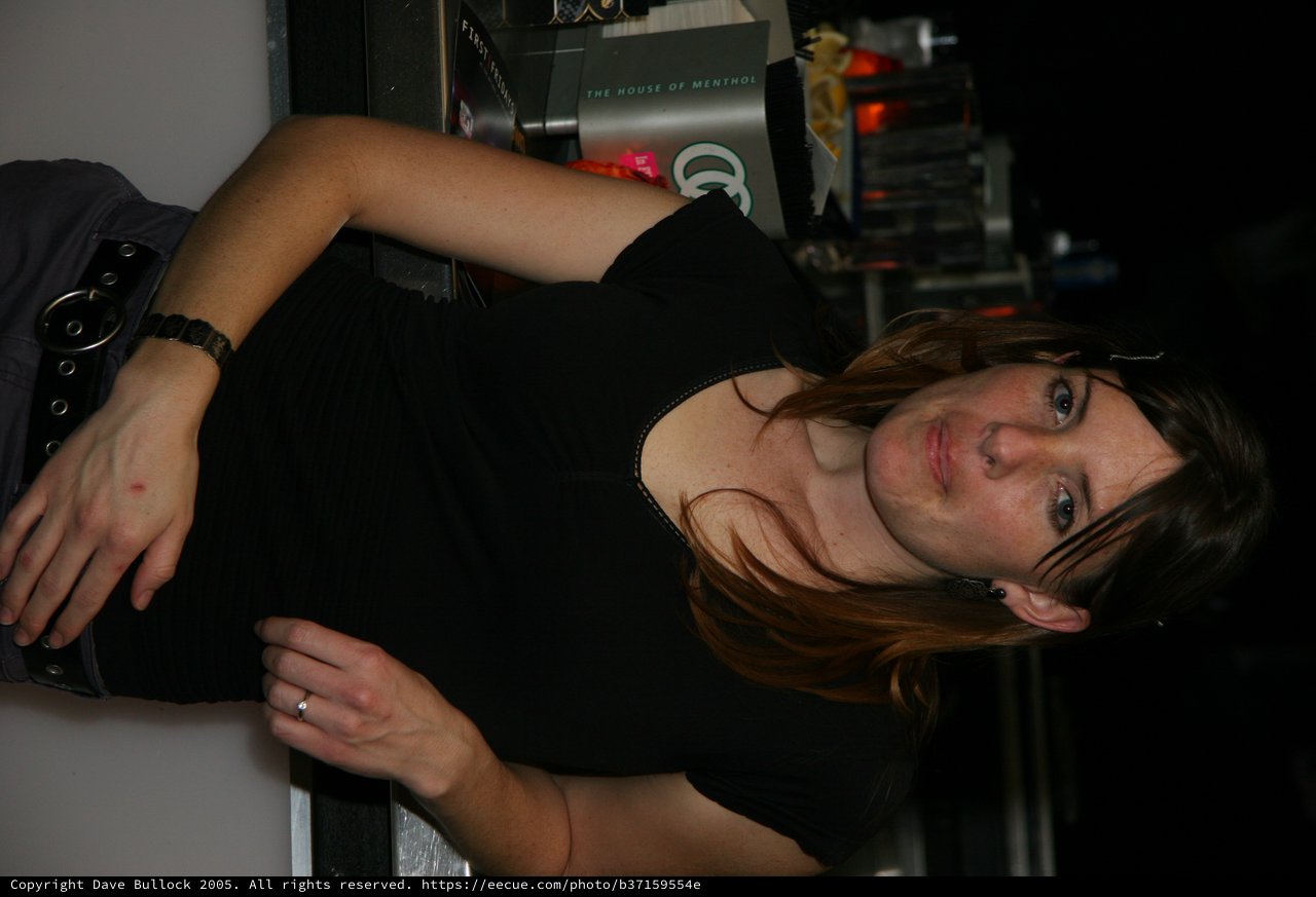 Woman at Bar Counter in Casual Black Attire