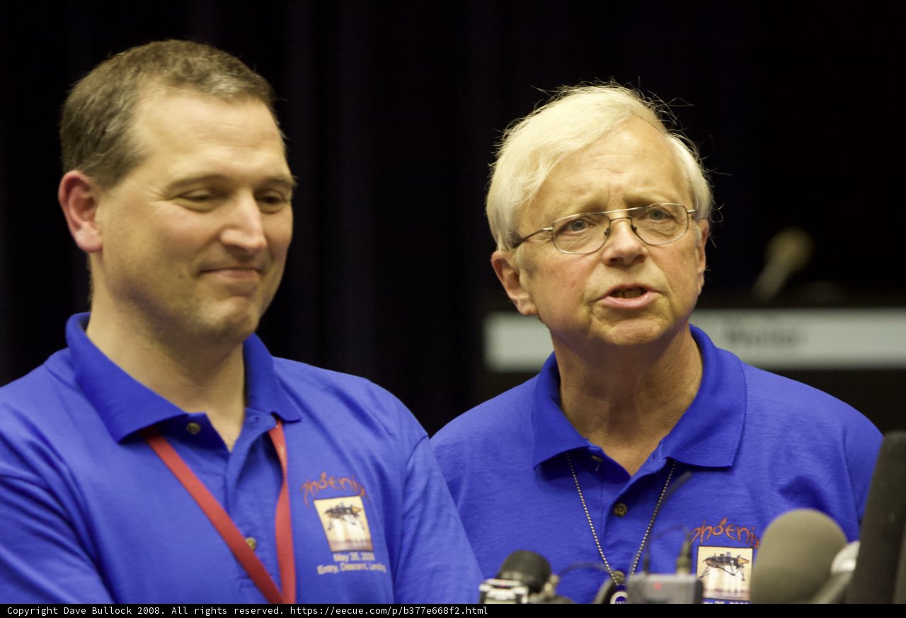 Blue-Shirted Men Address the Press