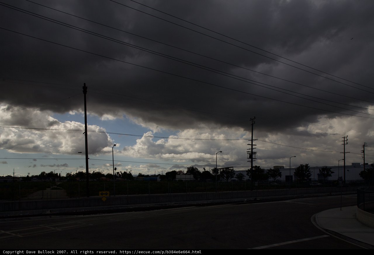 A Dark Sky over Power Lines and Street