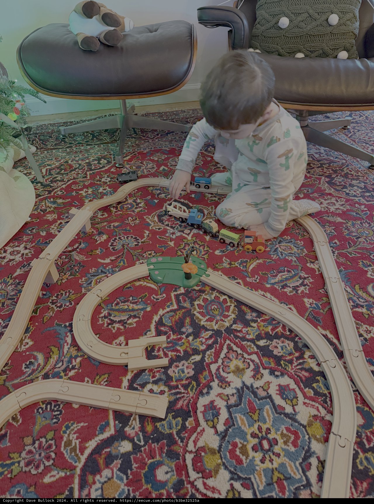 Toddler Playing with Wooden Train Set at Home