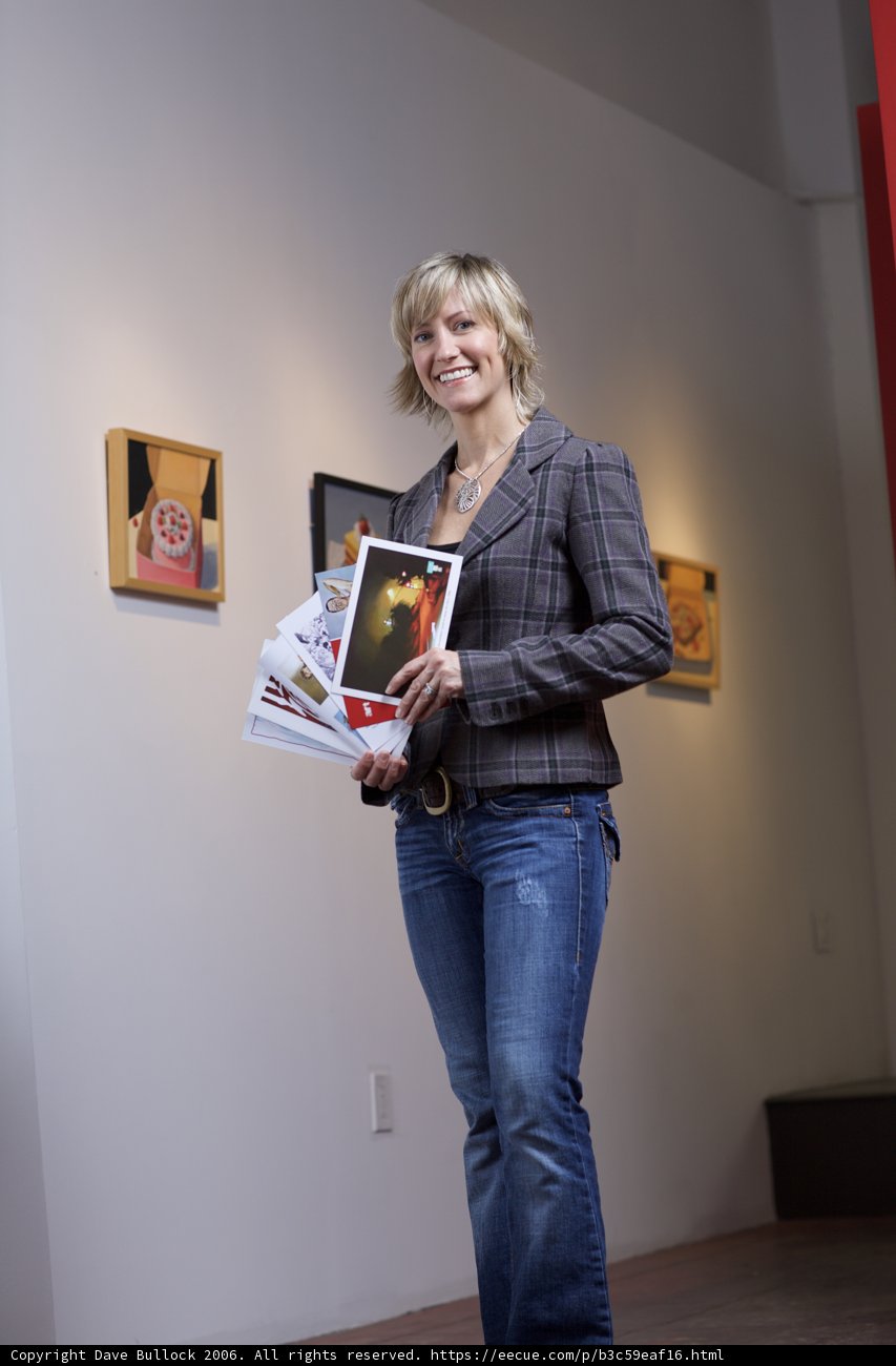 Woman Reading a Book with Art Gallery Poster in Background