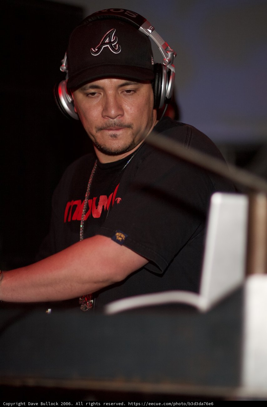 Man in Black Shirt with Headphones and Baseball Cap