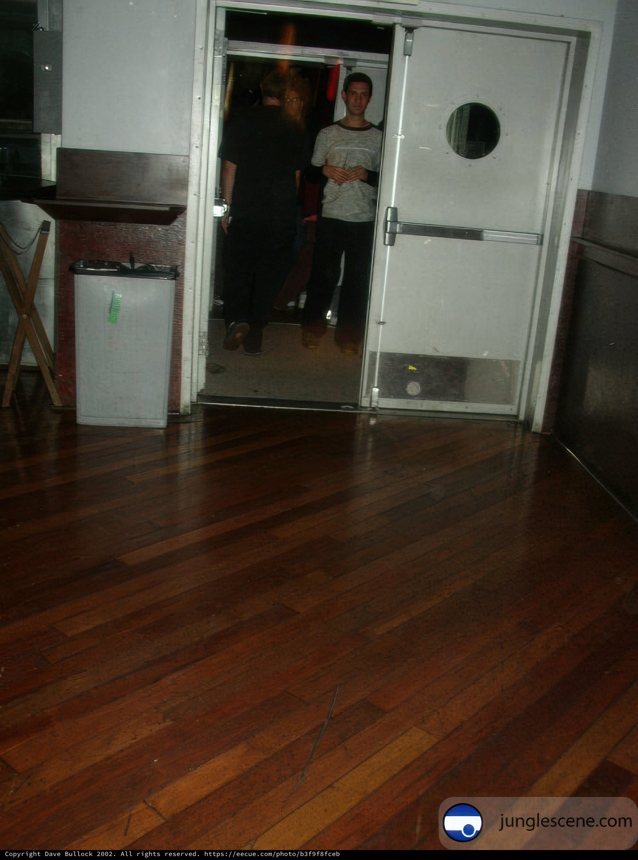 Wooden Flooring with a Door and a Trash Can