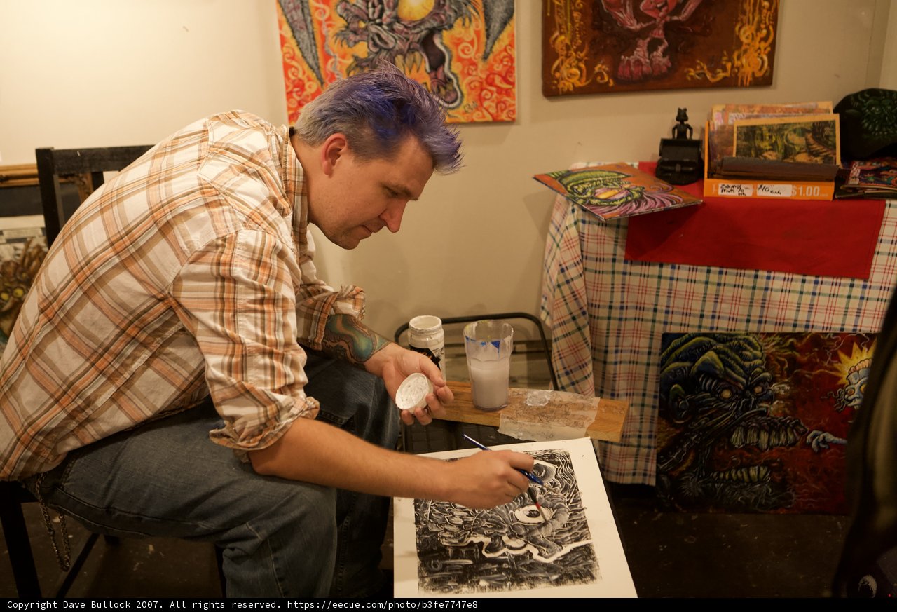 Purple-haired artist creating masterpiece on paper