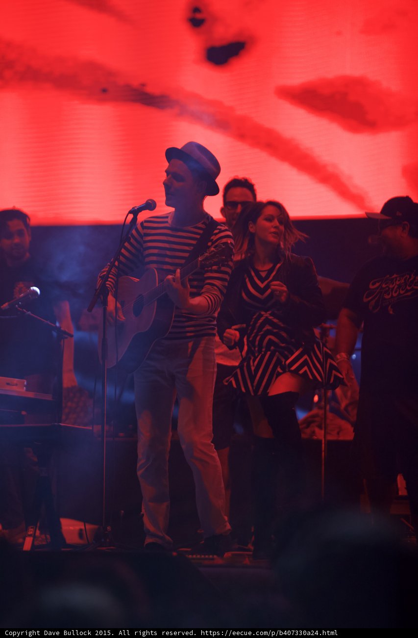 Belle and Sebastian Stuart Murdoch Singing Woman Chevron Dress Man Sunglasses Red Video Screen