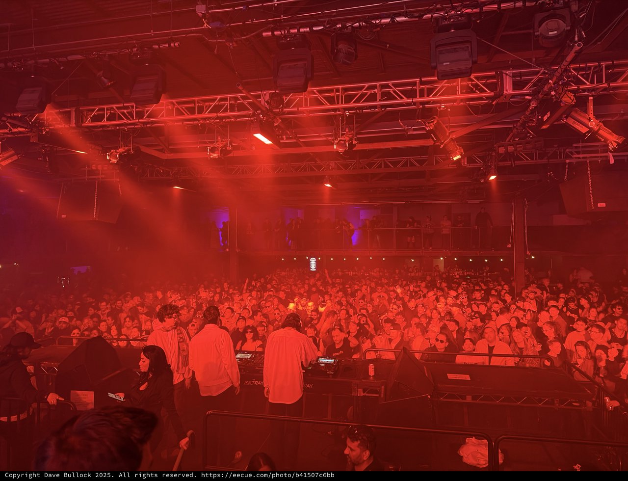 Red Light Concert Energy: DJ Performance at Packed Venue