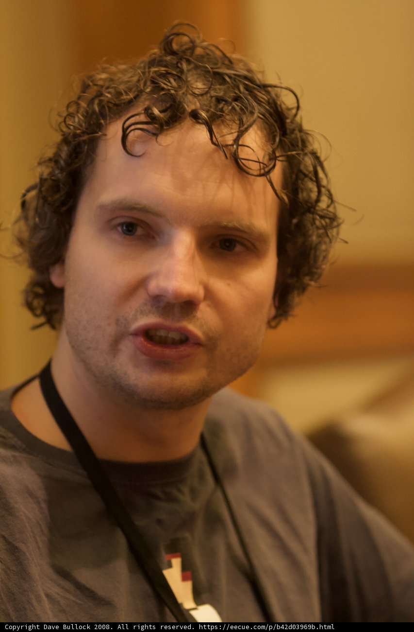 Curly Haired Man in Black Hat