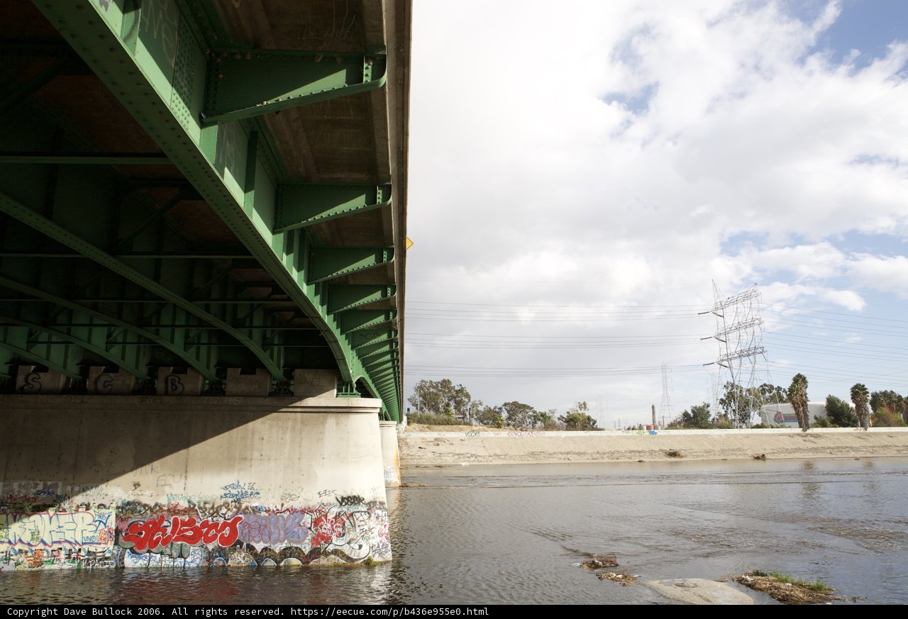 Colorful Graffiti on a Riverside Overpass