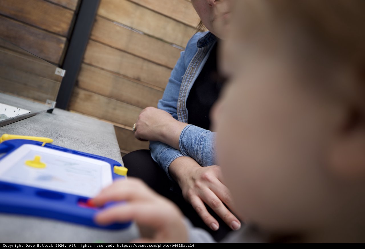 Children Drawing Together at Wooden Table