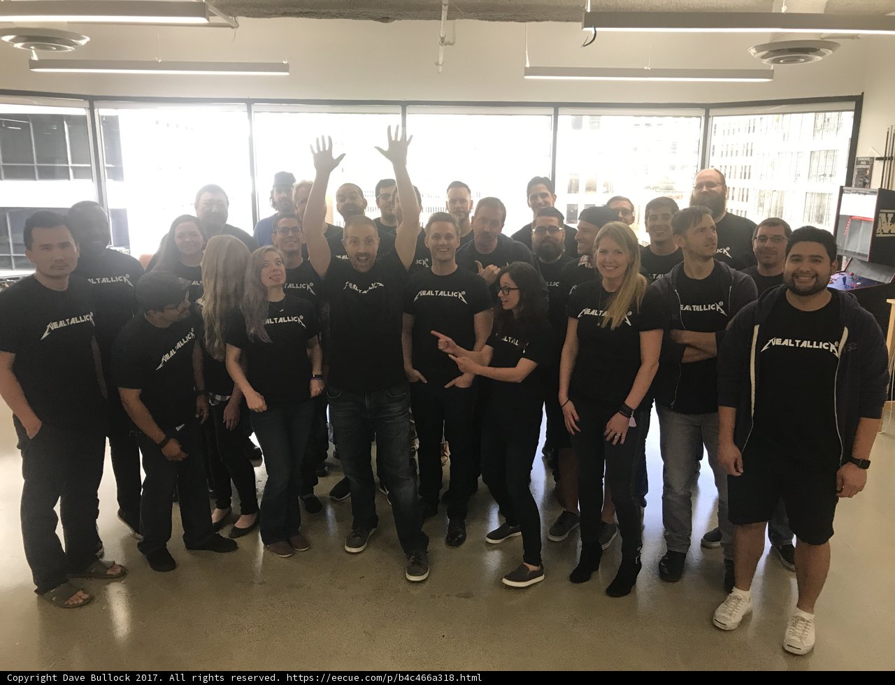Group of People in Black Shirts Strike a Pose