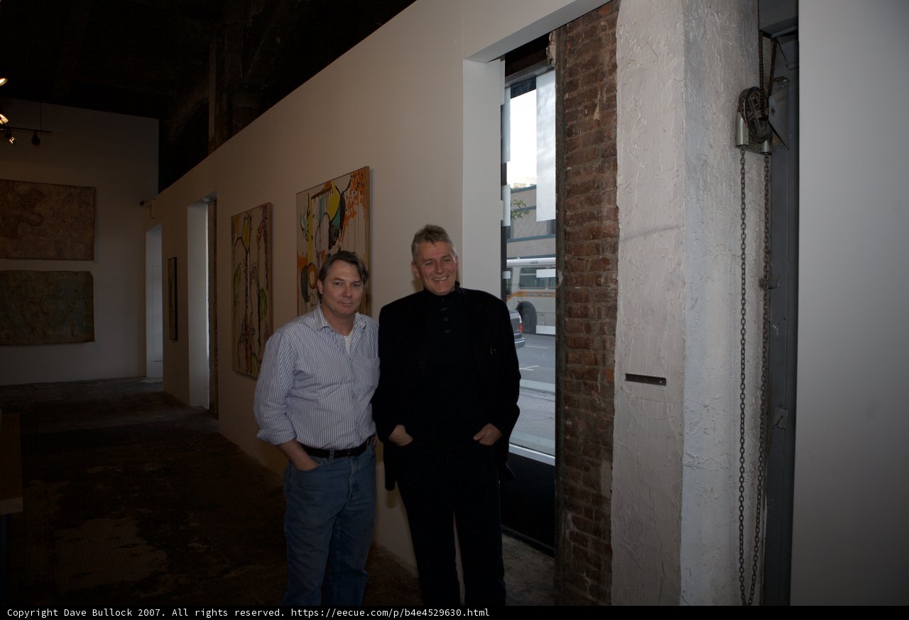 Two Men Admiring Art in a Corridor