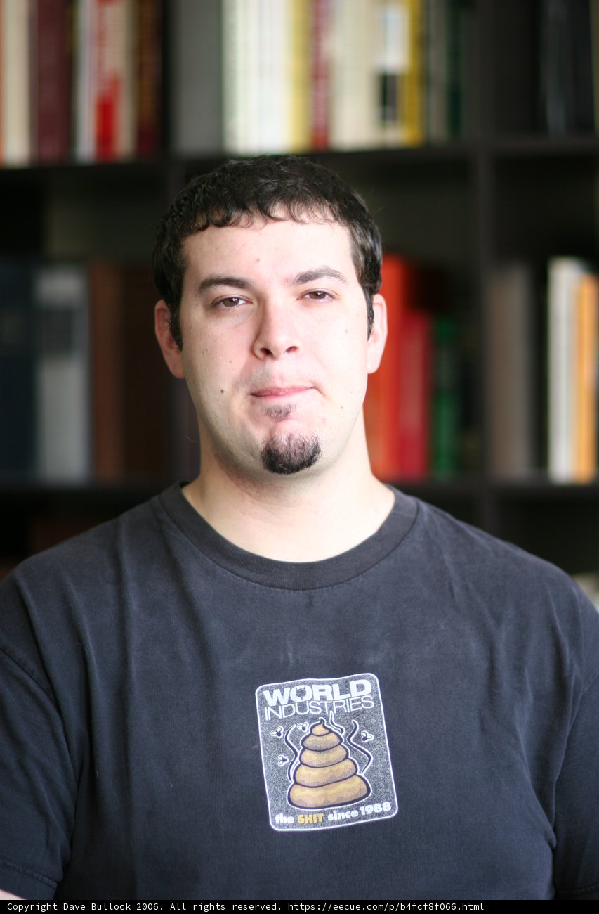 Man in Black T-Shirt Checking Out a Bookshelf