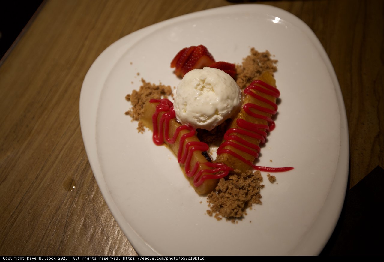 Artfully Plated Dessert with Ice Cream and Strawberry Coulis