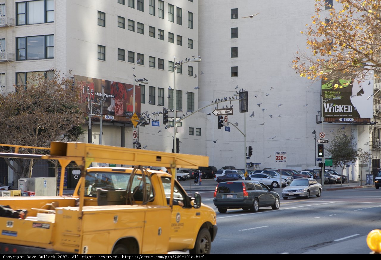 Yellow Pickup Truck on Busy City Street