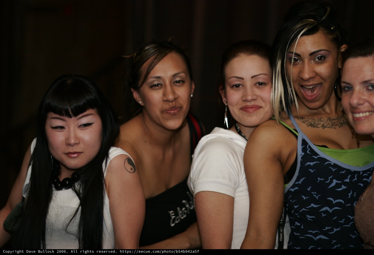 Four Friends Pose Together at Nightclub Anniversary Event
