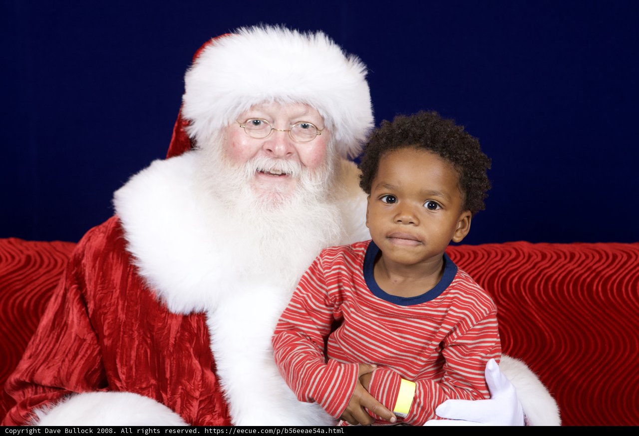 Santa Claus and Child Pose for Festive Photo
