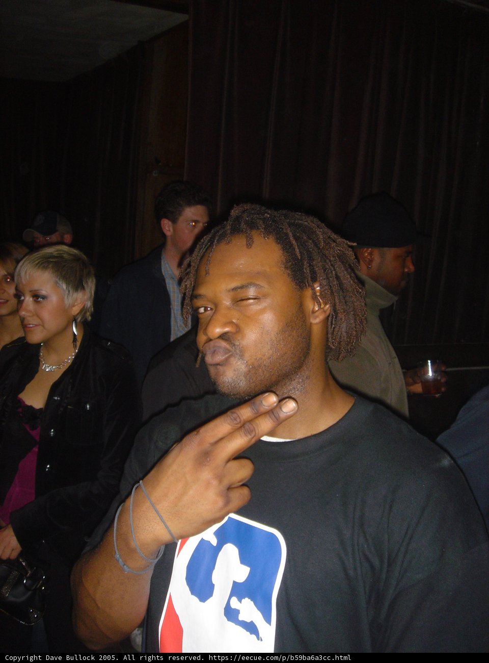 Urban Night Out Caption: James M rocks a black shirt and stylish baseball cap at the club with his friends.