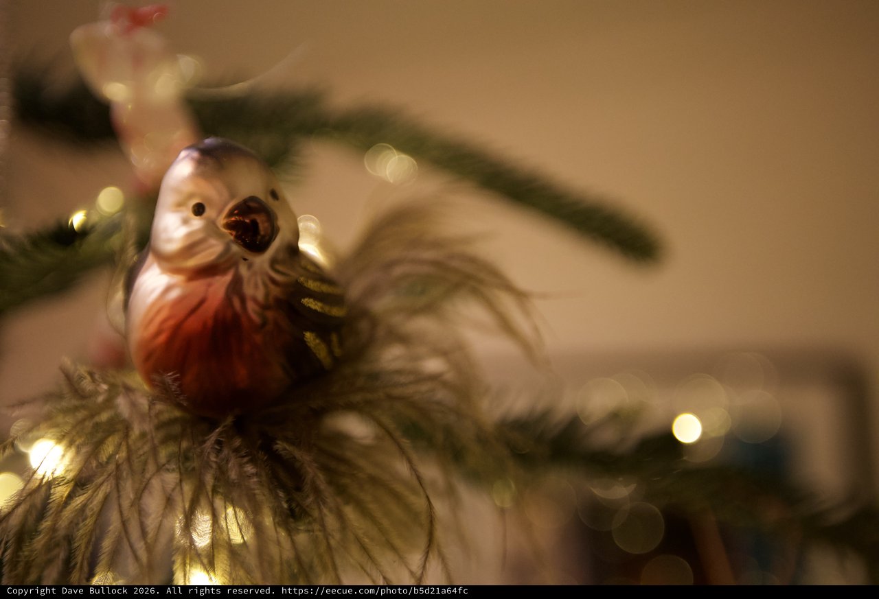 Singing Bird Christmas Ornament on Illuminated Tree